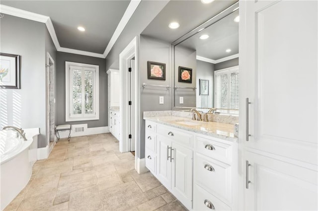 bathroom featuring vanity, a bath, visible vents, and ornamental molding