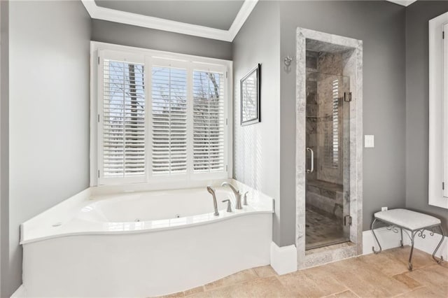 bathroom with a shower stall, crown molding, and a garden tub