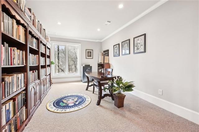 home office with visible vents, carpet floors, baseboards, and ornamental molding