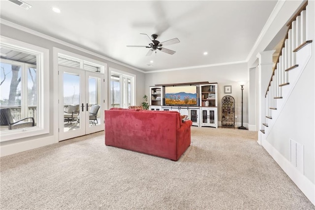 living area with visible vents, french doors, carpet, crown molding, and ceiling fan