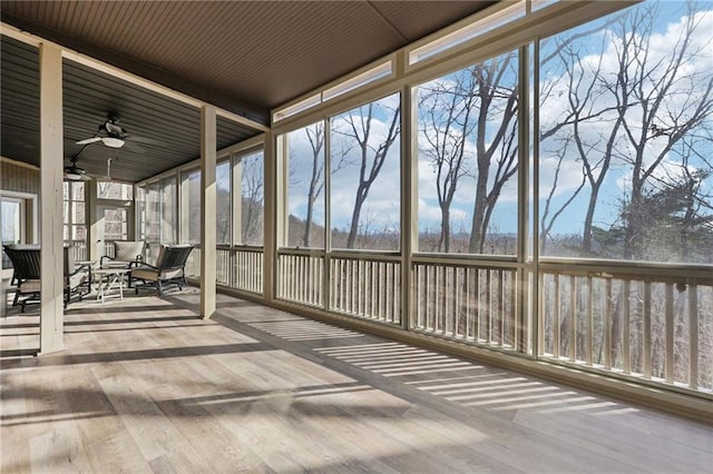 unfurnished sunroom with a wealth of natural light and a ceiling fan