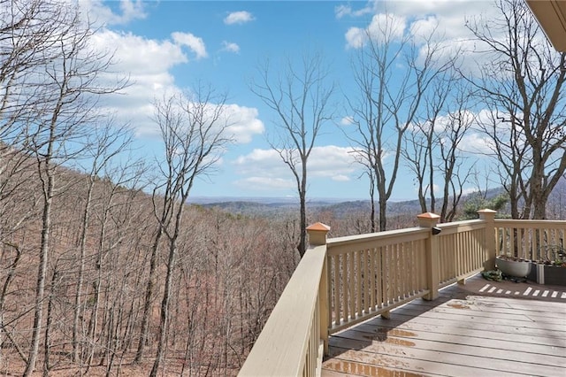 wooden deck featuring a wooded view