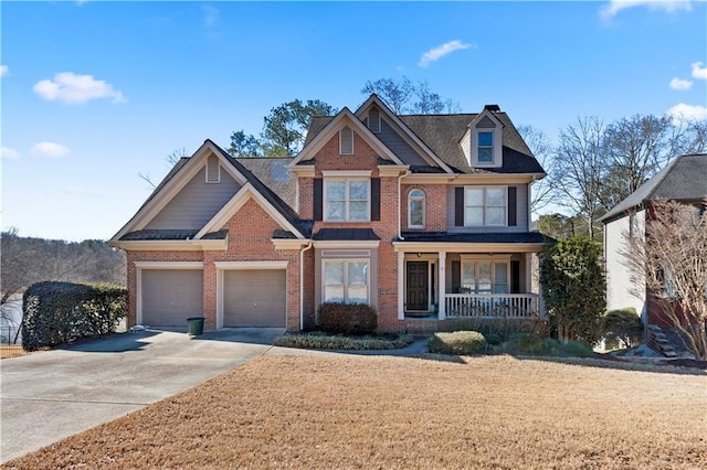 view of front of property with a garage, driveway, a porch, and brick siding