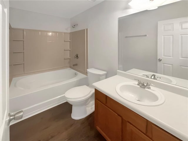 full bath with shower / washtub combination, toilet, vanity, and wood finished floors