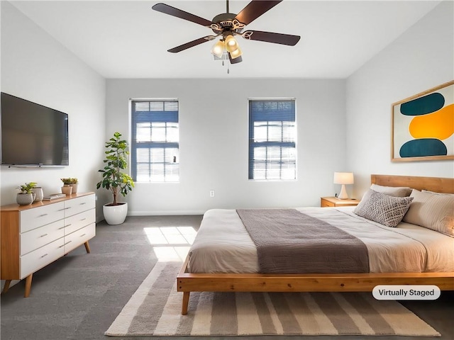 carpeted bedroom featuring baseboards and ceiling fan