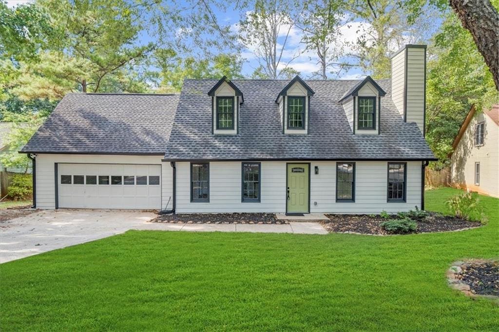 cape cod-style house with a front yard and a garage