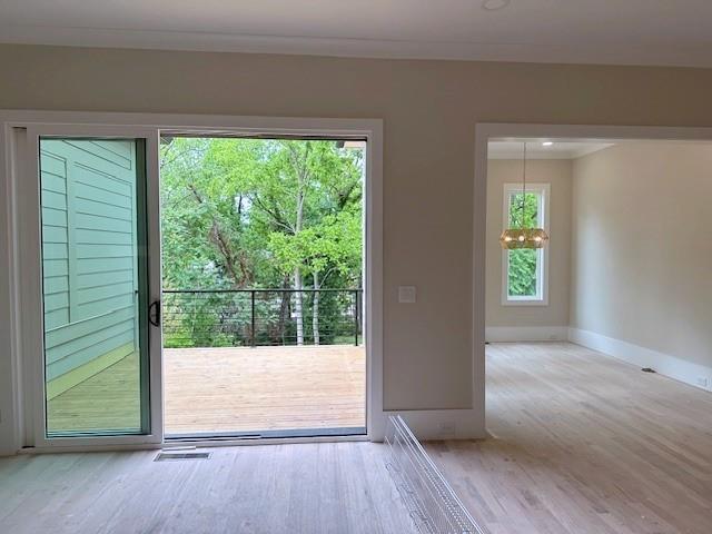 285 White St Unit 4, Marietta, GA 30060 - entryway featuring wood finished floors, crown molding, a chandelier, and baseboards