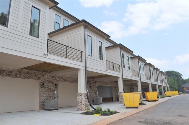 285 White St Unit 4, Marietta, GA 30060 - view of side of property with a garage, a balcony, central AC unit, and brick siding