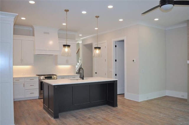285 White St Unit 4, Marietta, GA 30060 - kitchen with stainless steel range with gas stovetop, ornamental molding, a sink, ceiling fan, and white cabinets