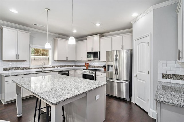 5696 Walnut Mill Ln, Powder Springs, GA 30127 - kitchen with appliances with stainless steel finishes, ornamental molding, backsplash, light stone counters, and dark wood-style floors