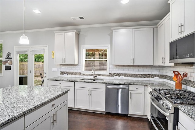 5696 Walnut Mill Ln, Powder Springs, GA 30127 - kitchen featuring appliances with stainless steel finishes, crown molding, dark wood finished floors, decorative backsplash, and light stone counters