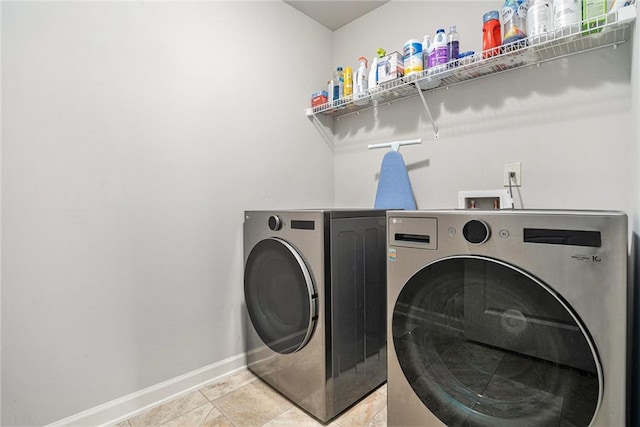 5696 Walnut Mill Ln, Powder Springs, GA 30127 - washroom featuring washer and clothes dryer and light tile patterned floors