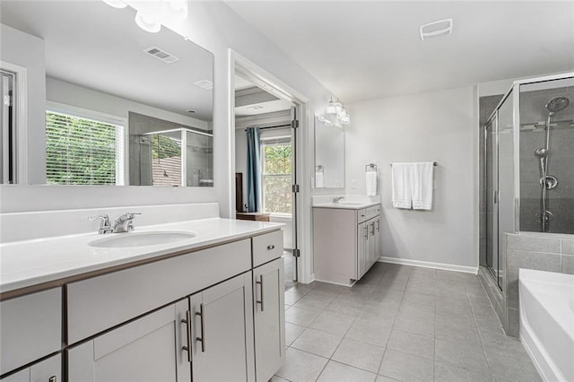 5696 Walnut Mill Ln, Powder Springs, GA 30127 - bathroom with a shower stall, two vanities, a bath, tile patterned floors, and healthy amount of natural light
