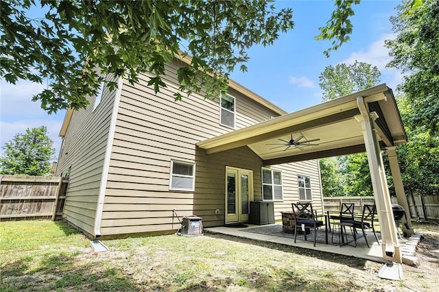 5696 Walnut Mill Ln, Powder Springs, GA 30127 - back of house featuring a ceiling fan, a fenced backyard, and a patio