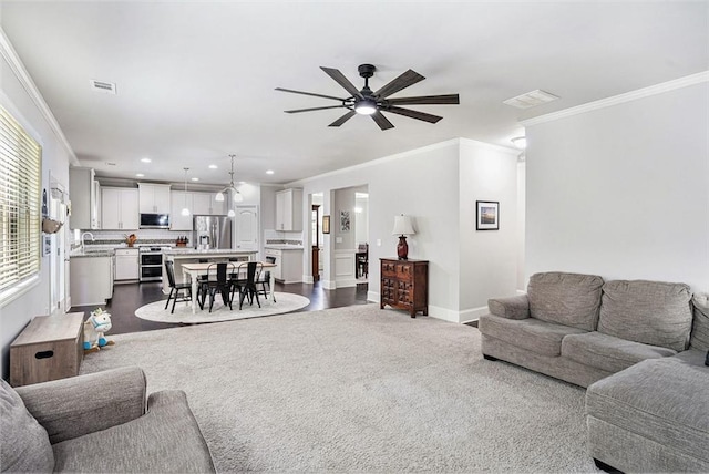 5696 Walnut Mill Ln, Powder Springs, GA 30127 - living area featuring crown molding, a ceiling fan, recessed lighting, and dark carpet