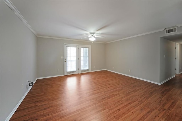 spare room with crown molding, dark wood-type flooring, and ceiling fan