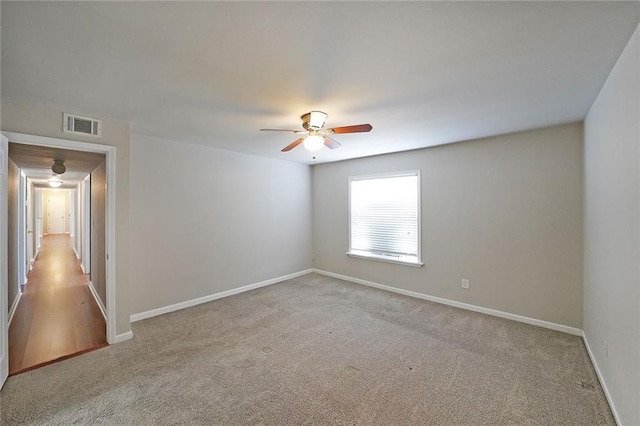 carpeted spare room with ceiling fan