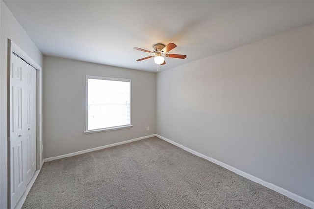 unfurnished bedroom featuring carpet flooring, ceiling fan, and a closet