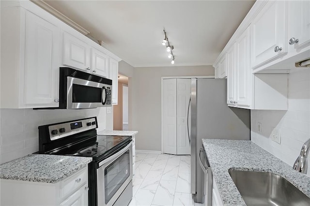 kitchen with white cabinetry, appliances with stainless steel finishes, and sink