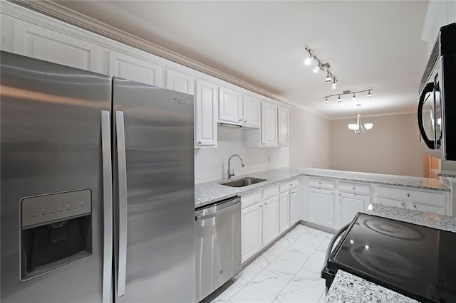 kitchen with sink, black appliances, white cabinets, decorative light fixtures, and kitchen peninsula