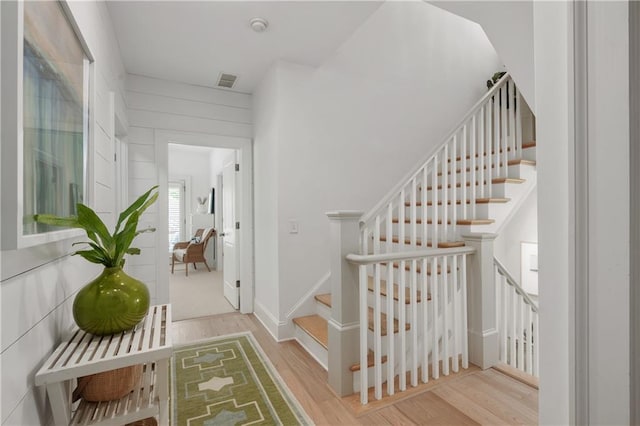stairs featuring visible vents and wood finished floors