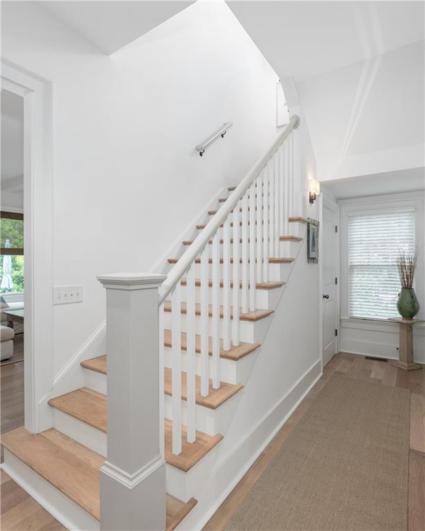 stairway featuring baseboards and wood finished floors