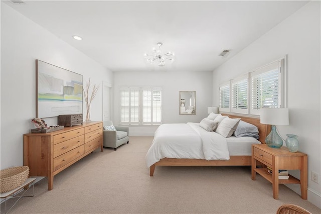bedroom with visible vents, a notable chandelier, multiple windows, and light colored carpet