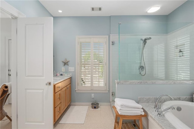 full bath featuring vanity, baseboards, visible vents, a bath, and a stall shower