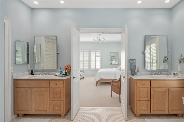 full bathroom with a sink, ensuite bathroom, and two vanities