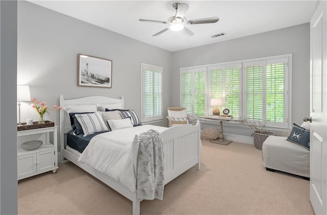 bedroom featuring multiple windows, light carpet, and visible vents