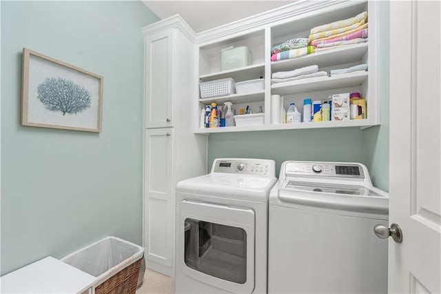 laundry room featuring cabinet space and washing machine and dryer