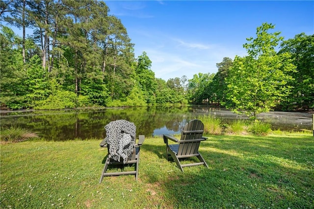 view of yard with a water view and a view of trees
