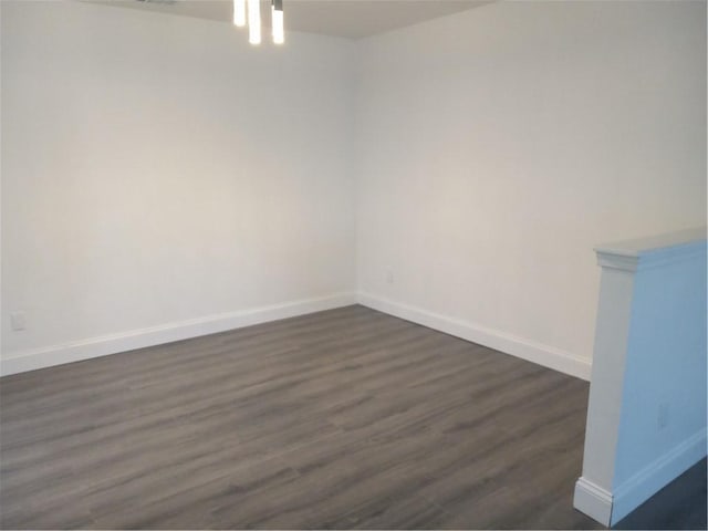 spare room with dark wood-type flooring