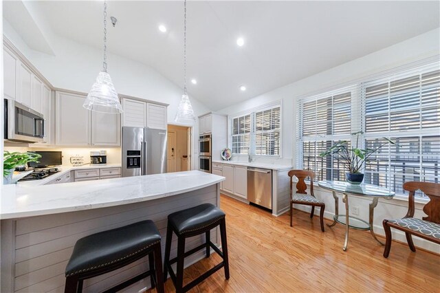 hall featuring a chandelier and light hardwood / wood-style floors