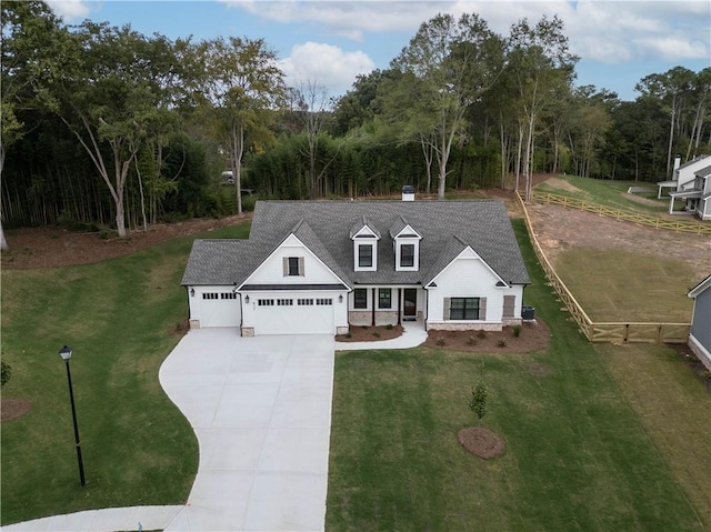 view of front of house with a garage and a front lawn