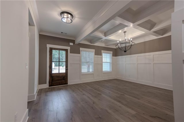 foyer with coffered ceiling, an inviting chandelier, ornamental molding, dark hardwood / wood-style flooring, and beamed ceiling