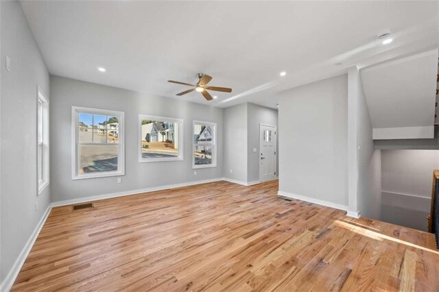 unfurnished living room featuring recessed lighting, wood finished floors, a ceiling fan, visible vents, and baseboards