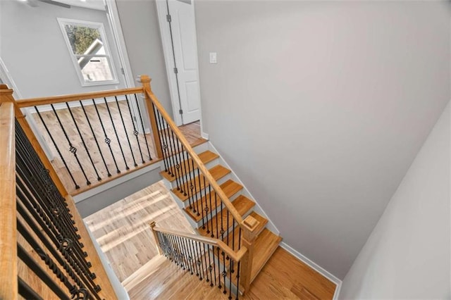 stairs featuring baseboards and wood finished floors