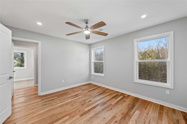 spare room with light wood-type flooring, baseboards, and recessed lighting