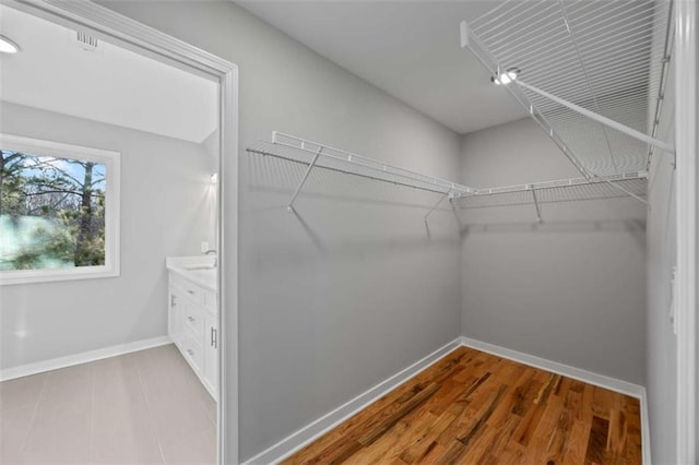 walk in closet featuring wood finished floors