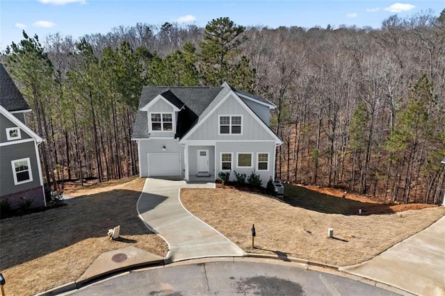 view of front of property featuring a view of trees and board and batten siding