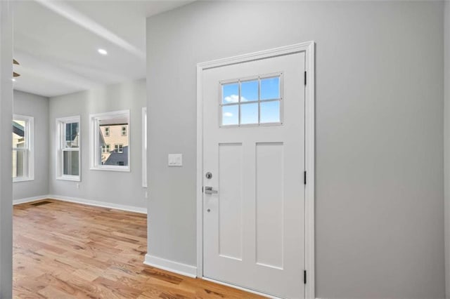 foyer featuring baseboards, recessed lighting, visible vents, and light wood-style floors