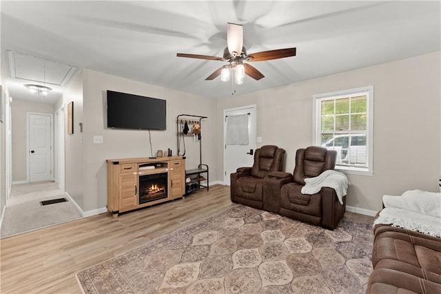 153 Garrison Dr, Cleveland, GA 30528 - living room featuring attic access, a ceiling fan, light wood-type flooring, and baseboards