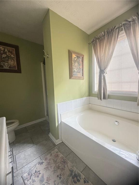 3484 Lynley Mill Ln, Dacula, GA 30019 - full bathroom featuring a garden tub, baseboards, toilet, tile patterned floors, and a shower