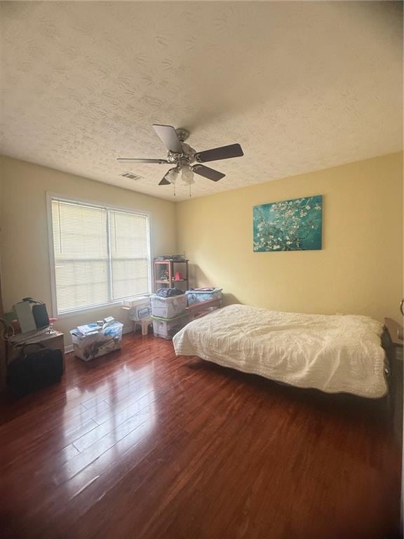 3484 Lynley Mill Ln, Dacula, GA 30019 - bedroom featuring wood finished floors, a textured ceiling, and ceiling fan