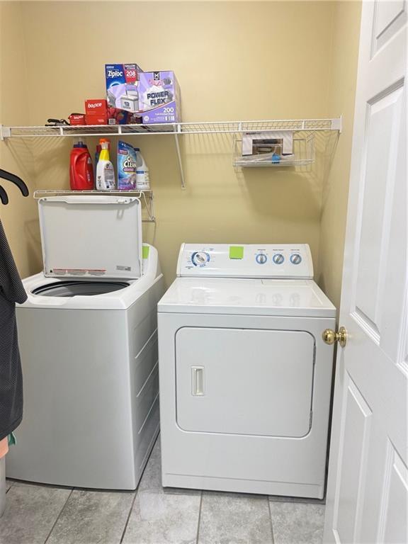 3484 Lynley Mill Ln, Dacula, GA 30019 - laundry area featuring separate washer and dryer and light tile patterned floors