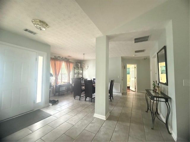 3484 Lynley Mill Ln, Dacula, GA 30019 - entrance foyer featuring a chandelier, a textured ceiling, and tile patterned flooring