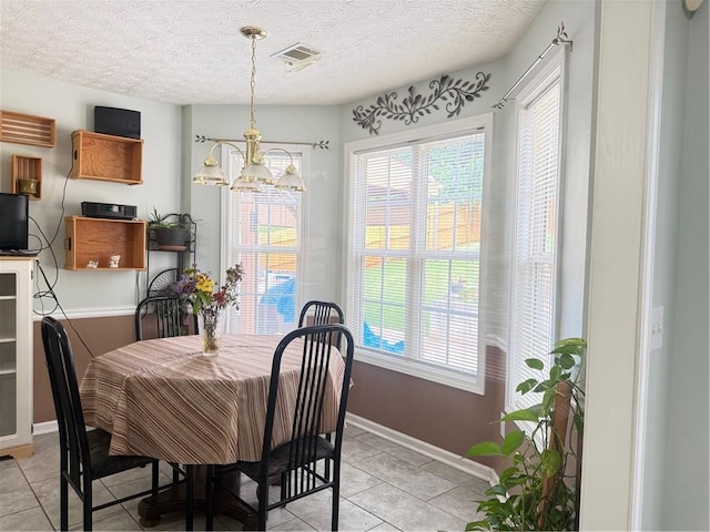 3484 Lynley Mill Ln, Dacula, GA 30019 - dining area featuring light tile patterned flooring, plenty of natural light, baseboards, a chandelier, and a textured ceiling