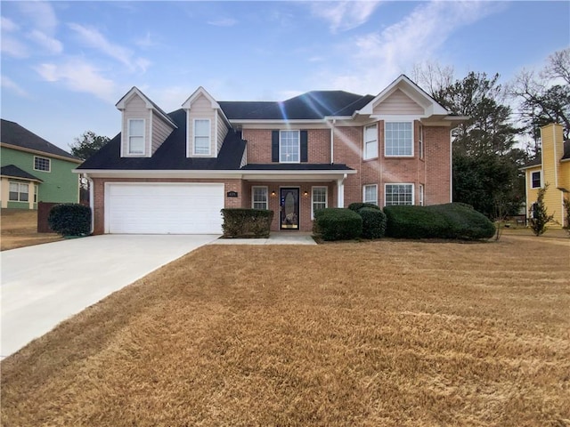 view of front facade featuring an attached garage, a front yard, concrete driveway, and brick siding