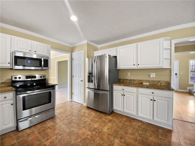kitchen with ornamental molding, appliances with stainless steel finishes, and white cabinets